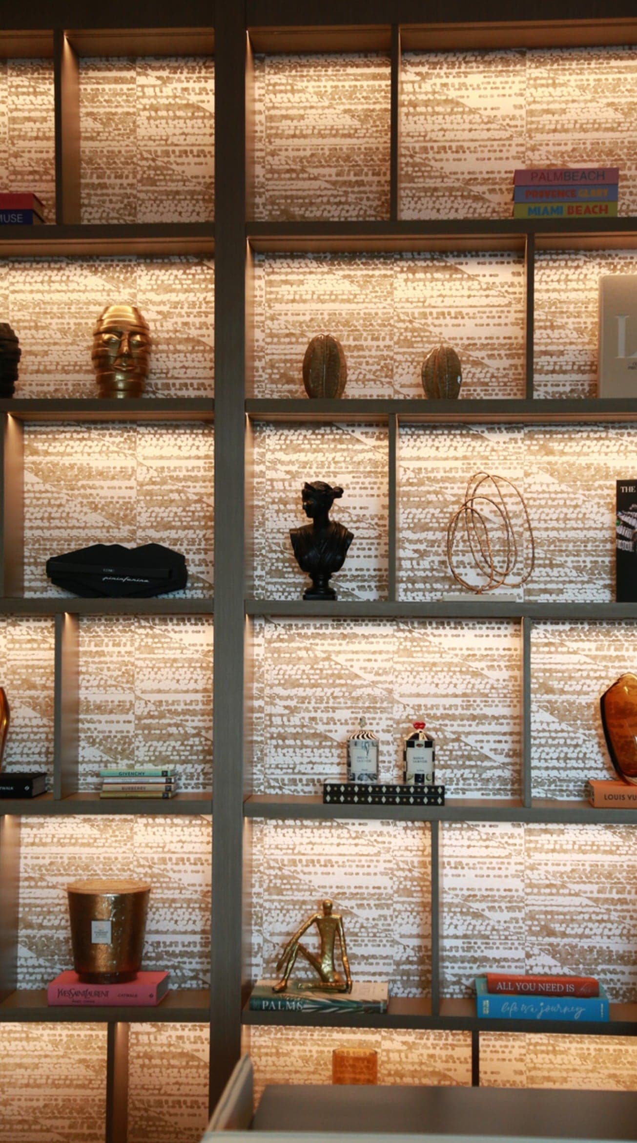 Backlit display cabinet with textured rear panels and glass shelving