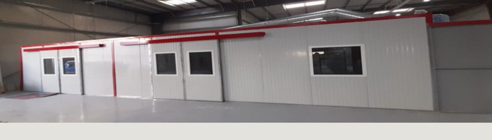 The separate sanding, drying, primer and final finishing rooms on the workshop floor