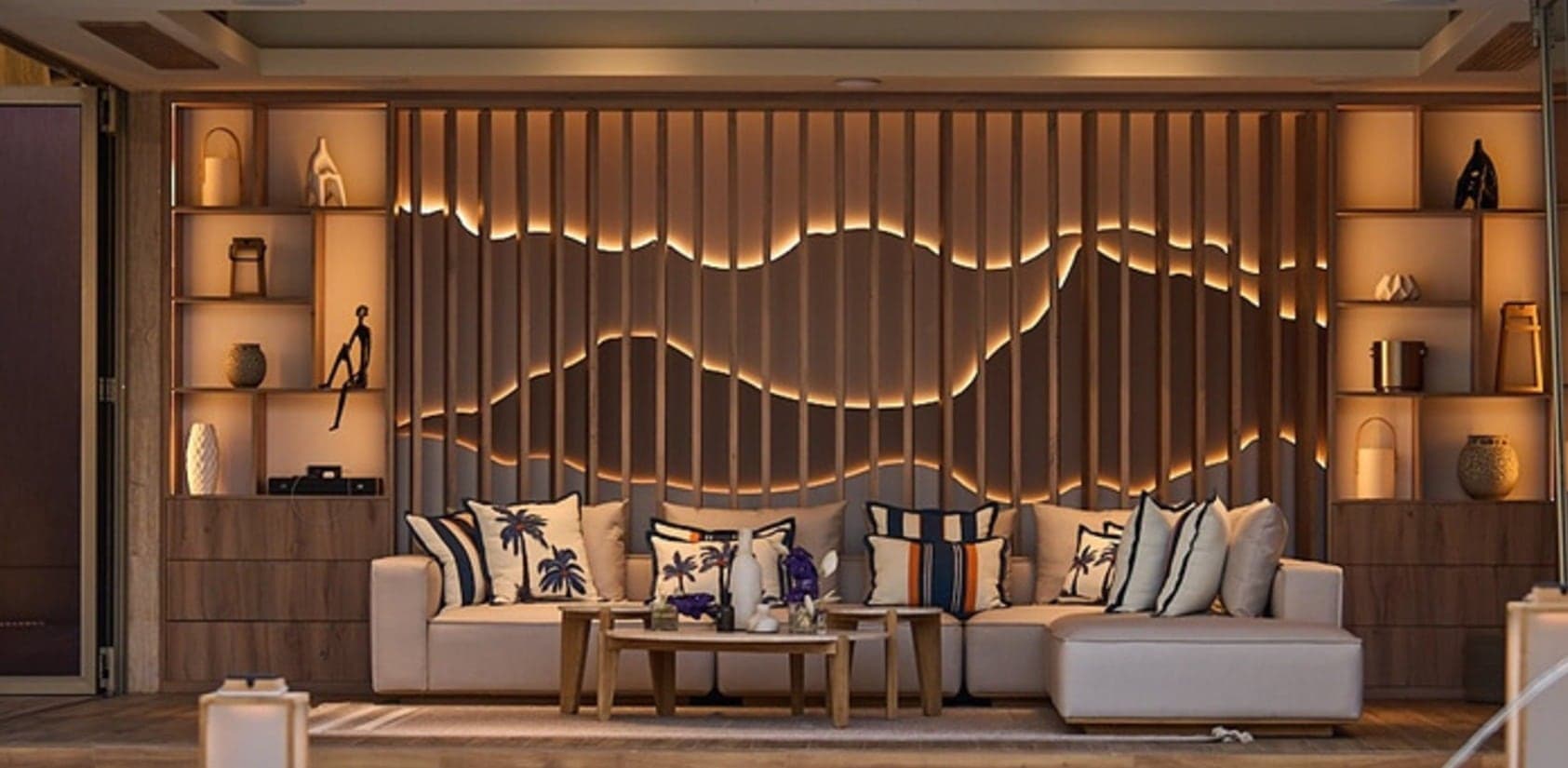 Sculpted feature wall with backlit contoured timber fins, display shelving and warm concealed lighting