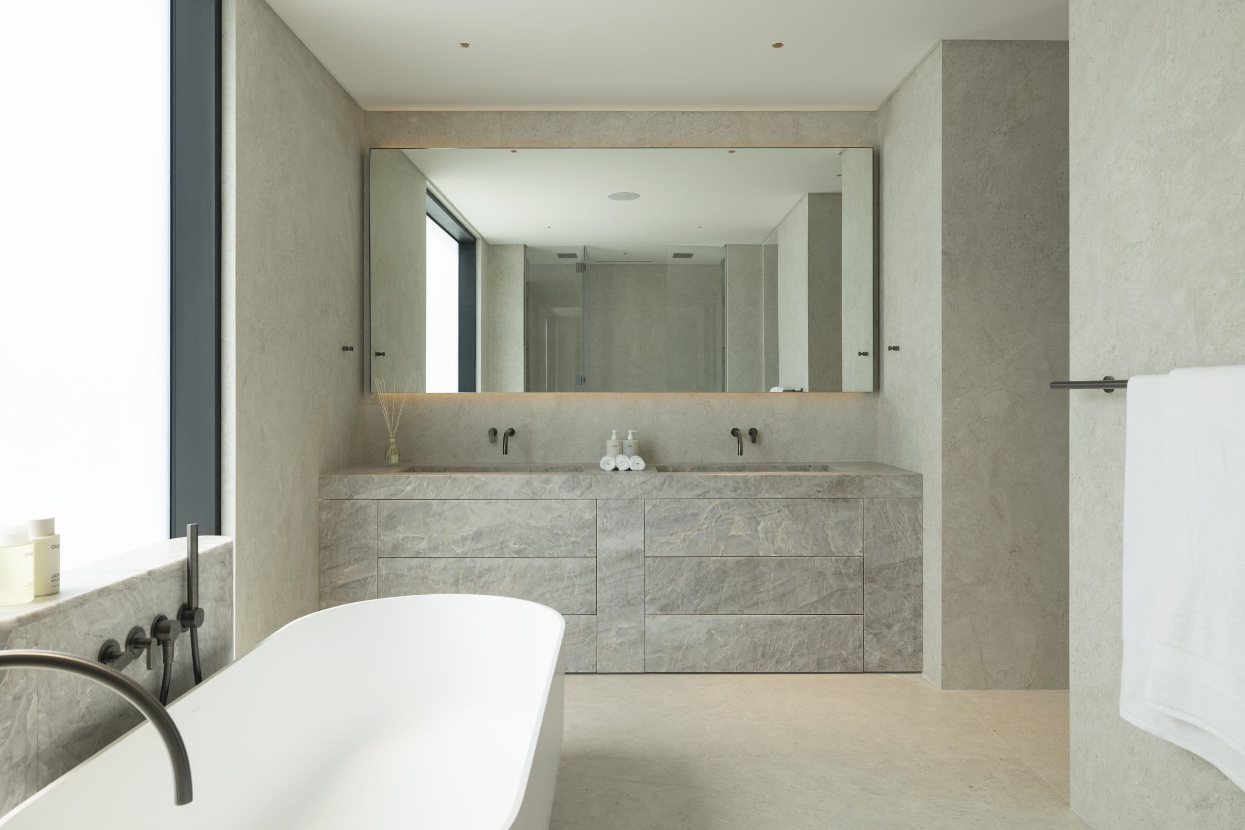 Master bathroom with a grey marble vanity and full-width mirror