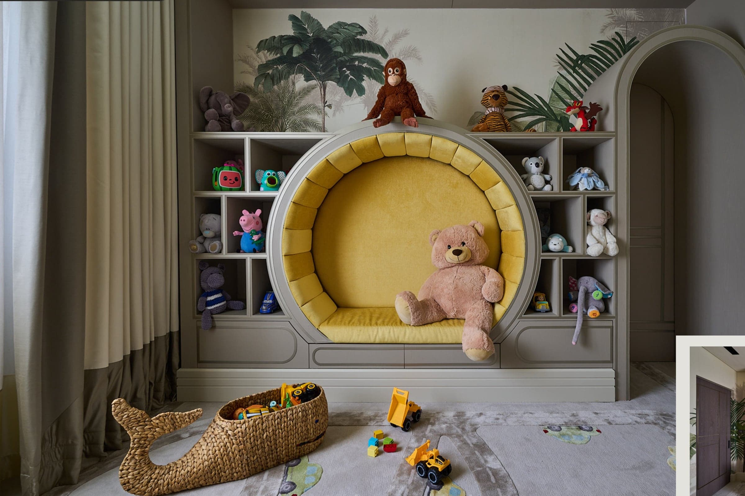 Children's room with an arched built-in reading nook and open toy shelving