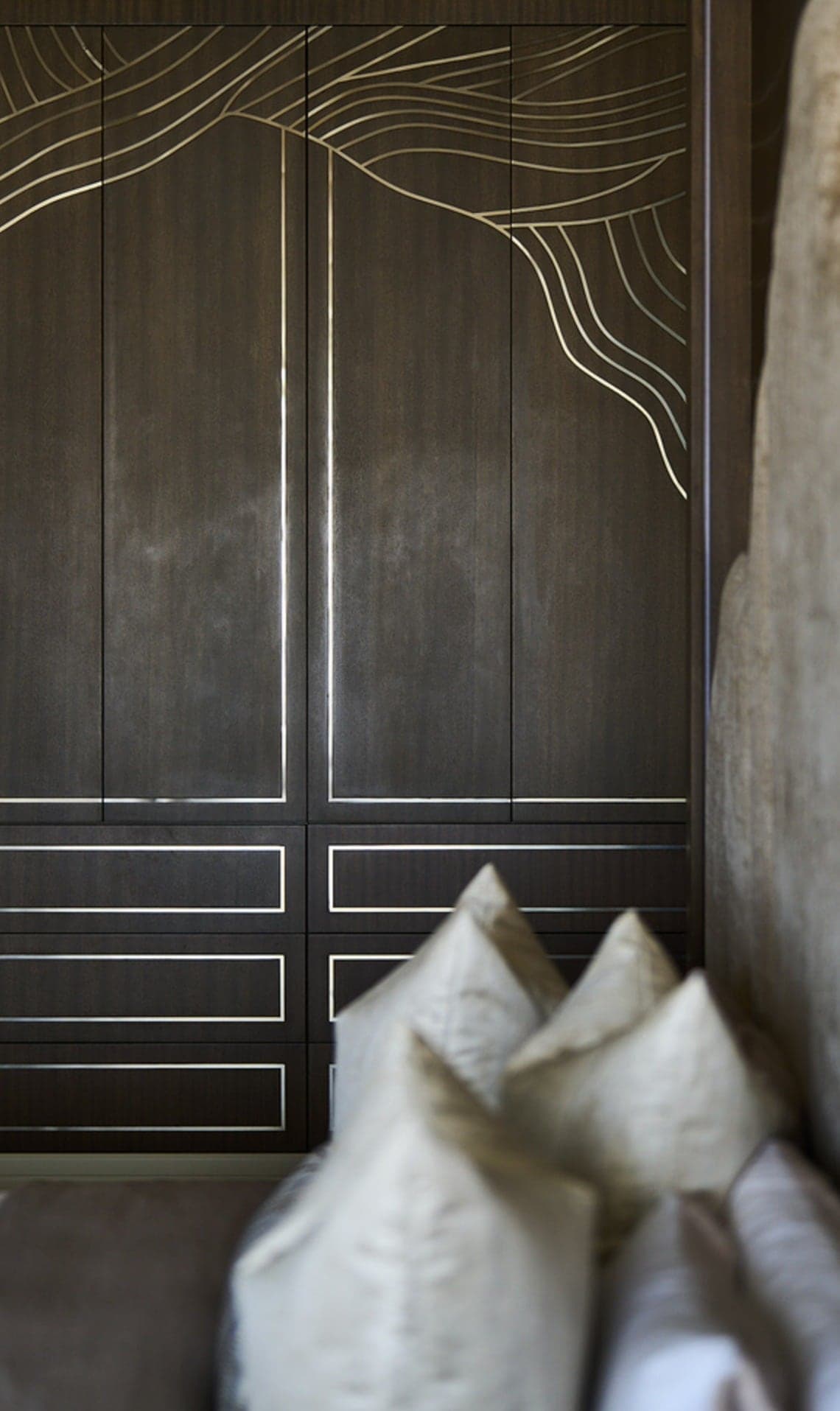 Dark panelled wardrobe doors with recessed line detailing
